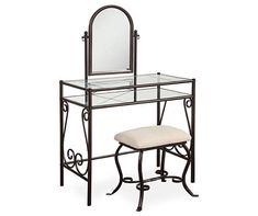 a vanity table with a mirror and stool