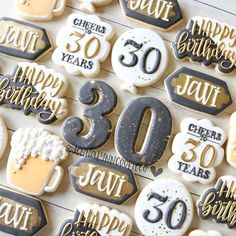 some cookies that are decorated to look like 30th birthdays and celebrating 50 years on them