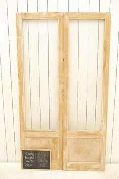 an open wooden door with a chalkboard on the front and side panels that say code alla