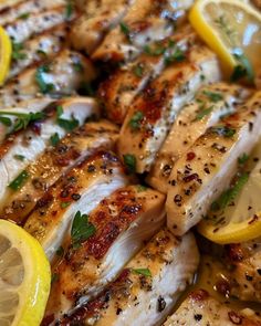 chicken with lemon slices and herbs on it