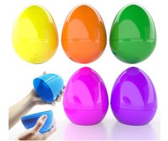 several different colored plastic eggs with one being held by someone's hand and the other is