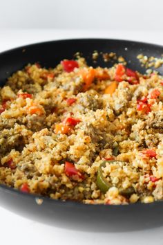 a skillet filled with food on top of a white table