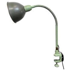 an old green desk lamp on a white background