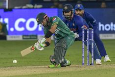 a cricket player hitting the ball with his bat