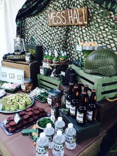 a table topped with lots of food and drinks next to a sign that says mess hall