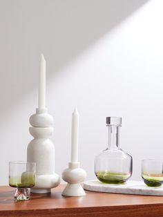 a table with candles, bottles and glasses on it