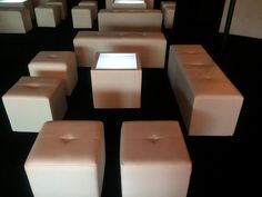 a room filled with lots of white square stools