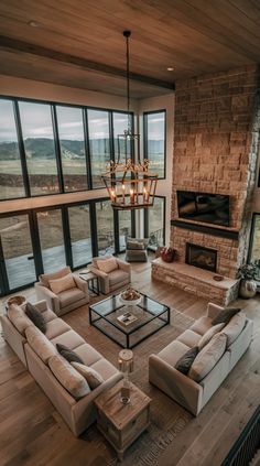 a living room filled with furniture and a fire place in front of a large window