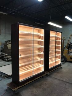 an empty display case in a warehouse with lights on