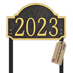 a black and gold address sign with a price tag hanging from it's side