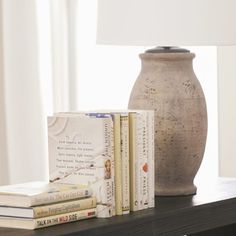 a table with books and a lamp on it