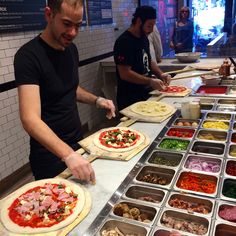 a man making pizzas at a restaurant