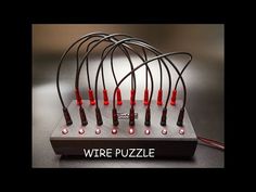 the wires are connected to each other on top of an electronic device that says wire puzzle