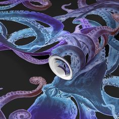 an octopus wallpaper with blue and purple tentacles on it's black back ground