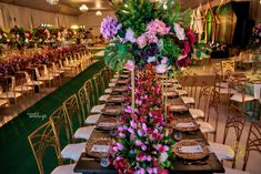 the tables are set with flowers and place settings for guests to sit down at them