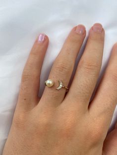 14K solid gold ring with an open top design with one pearl on one side and a diamond moon on the other side. A lovely one-of-a-kind design perfect for any occasion. Features * Gold KT: 14K * Diamond Cut: Round * Setting Type: Prong Set * Number of Stones: Five * Total Diamond Weight: 0.05 tcw * Diamond Color Clarity: G-H color SI-VS Clarity If you want this ring with color gemstones, please send us a message, and we will quote you a price with your desired stones. Return policy: Sizes below 5 an Elegant Rings With Moon Charm For Anniversary, Baguette Cut Ring, Stackable Diamond Rings, Moon Ring, Mother Rings, Birthday Ring, Mother Birthday Gifts, Gold Diamond Earrings, Gold Diamond Rings