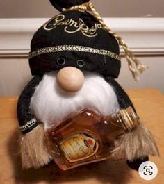 a stuffed animal wearing a hat and holding a bottle