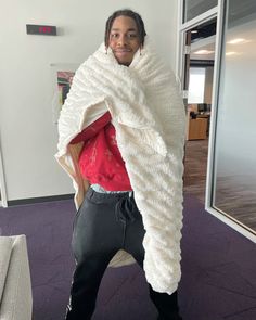 a man is wrapped in a blanket and posing for the camera