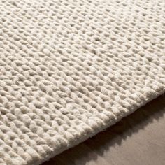 the textured fabric is white and has small dots on it, as well as an area rug