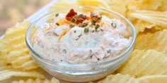 a bowl filled with food sitting on top of chips