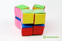 there is a colorful cube that has been folded into four pieces and sits on a white surface