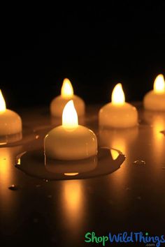 several lit candles sitting on top of a table