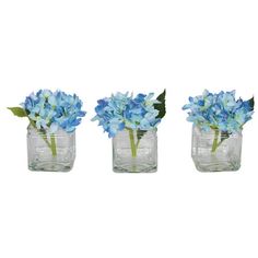 three glass vases with blue flowers in them