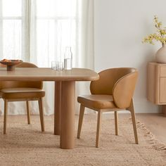 a wooden table with two chairs and a vase