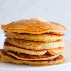 a stack of pancakes sitting on top of a white plate