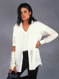 michael jackson in white shirt and black pants with hand on hip, posing for the camera