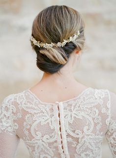 the back of a woman's head wearing a wedding dress