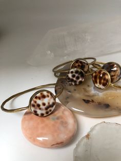 Tiger shell bangle statement hand made, fair trade ,made in Bali. This bangle will uplift any outfits  perfect for a shell lover ! a boho must ! Bohemian Mother Of Pearl Shell Gift, Bohemian Shell Bracelets As Gift, Bohemian Shell Bracelets For Gifts, Bohemian Cuff Bracelet Bangle For Beach, Bohemian Bangle Cuff Bracelet For The Beach, Bohemian Beach Cuff Bracelet Bangle, Bohemian Handmade Shell-shaped Bracelets, Bohemian Cuff Bangle For Beach, Bohemian Mother Of Pearl Bracelet