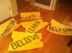 five wooden signs that say lead, don't leave and believe on the floor