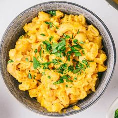 a bowl filled with macaroni and cheese on top of a table