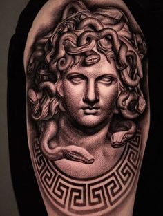 a woman's arm with a tattoo on it and an image of the head of med