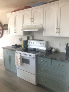 a white stove top oven sitting inside of a kitchen