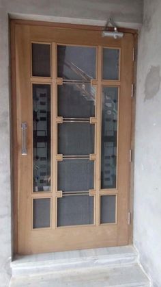 a wooden door with glass panels on the outside