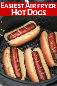 four hot dogs in buns sitting inside an air fryer with the words easyest air fryer hot dogs