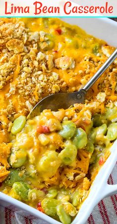 a casserole dish filled with green beans, cheese and bread crumbs