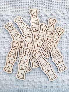 some type of wooden stickers on a white cloth