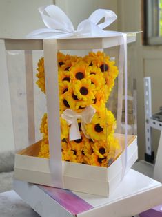 a white box with sunflowers in it