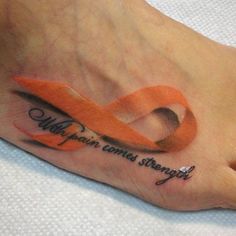 an orange ribbon with the words walk your own paths through it on someone's foot