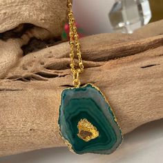 Looking for that "oomph" factor? Our 24k gold-dipped necklace, showcasing a dazzling green agate pendant, is your ticket to the glam express! This cheeky stunner turns heads and sparks conversations. From brunch with the girls to swanky soirées, this versatile piece is your new BFF. The green agate is all about balance and harmony, so you'll be oozing good vibes, darling! Act fast, fashionistas! Snag your Emerald Drop Necklace before it's poof gone! Features: 2" extender Lightweight Comfortable Green Spiritual Jewelry For Party, Green Spiritual Jewelry For Parties, Gold Agate Crystal Necklace For Gifts, Gold Emerald Necklace With Natural Stones As Gift, May Birthstone Gemstone Necklace For Party, Green Agate Necklace For Gift, Green Agate Crystal Necklace As Gift, Green Gold-plated Necklace For Party, Gold Necklaces With Natural Stones For Party