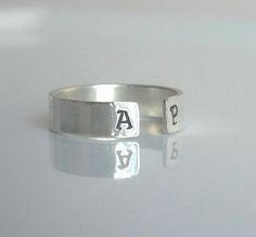 "Dainty and beautiful, this open sterling silver personalized initial ring is great by itself or stacked. On each end you can have your first and last initials stamped, or simply the first initial of you and your loved one!! Approximately 4mm wide. Please don't forget to leave a message in the \"note to seller\" field upon checkout letting me know the two initials that you would like to have stamped. The font I use is upper case Arial. If you would like your initials to be in lower case Arial, p Relationship Rings, Personalized Initial Ring, Couples Ring, Claddagh Ring, Gumball Machine, Initial Ring, Silver Bangle Bracelets, Upper Case, Personalized Initials