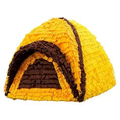 a yellow and brown dog house made out of straw