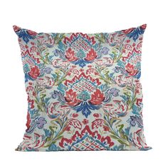 an embroidered pillow with red, blue and green flowers on white background in the shape of a flower