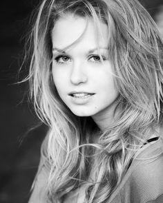 a black and white photo of a woman with long hair