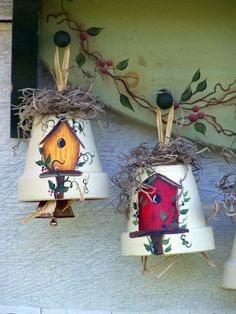 three birdhouses painted on the side of a building