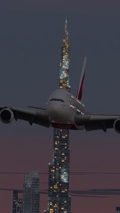 an airplane is flying over the city at night