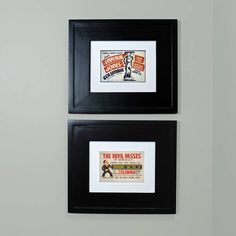 two framed posters are hanging on the wall